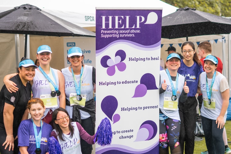 Group of smiling HELPathon runners after participating in the Auckland Marathon.